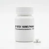 2F-DCK 100MG Pellets: opaque white HDPE pill jar and pressed 2-fluorodeschloroketamine reference pellets for analytical calibration.