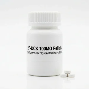 2F-DCK 100MG Pellets: opaque white HDPE pill jar and pressed 2-fluorodeschloroketamine reference pellets for analytical calibration.